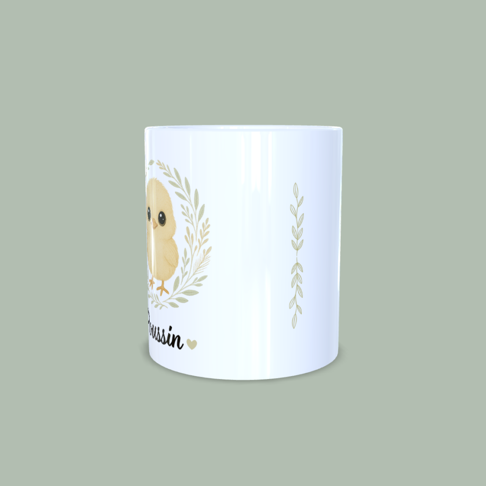Mug poussin avec couronne de fleurs et liseré de feuilles au centre.